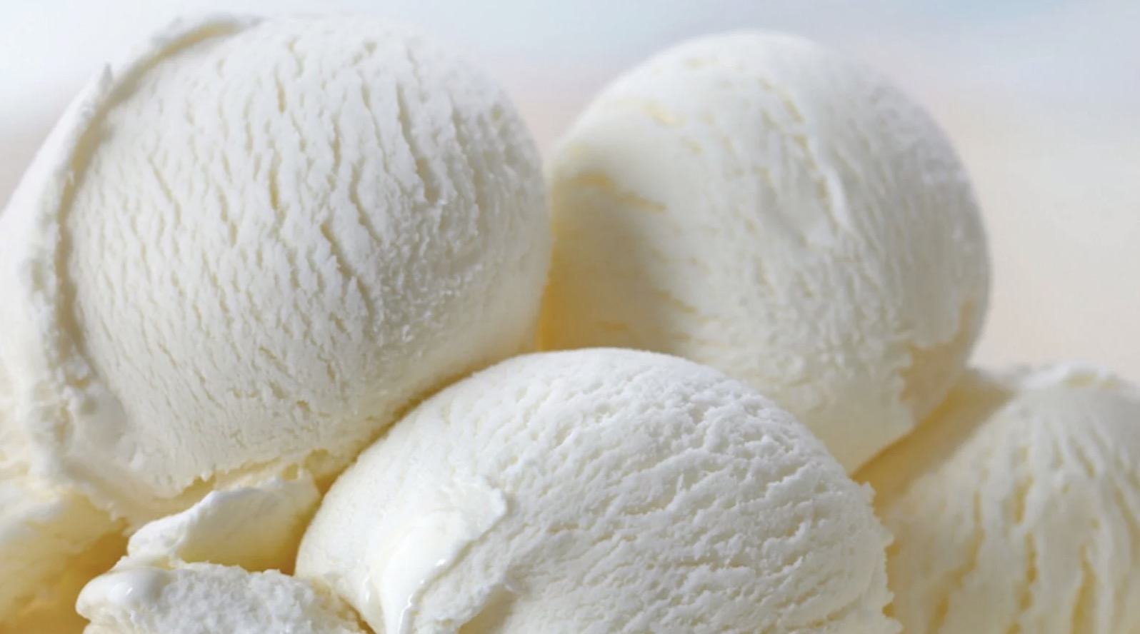 Three scoops of creamy vanilla ice cream.