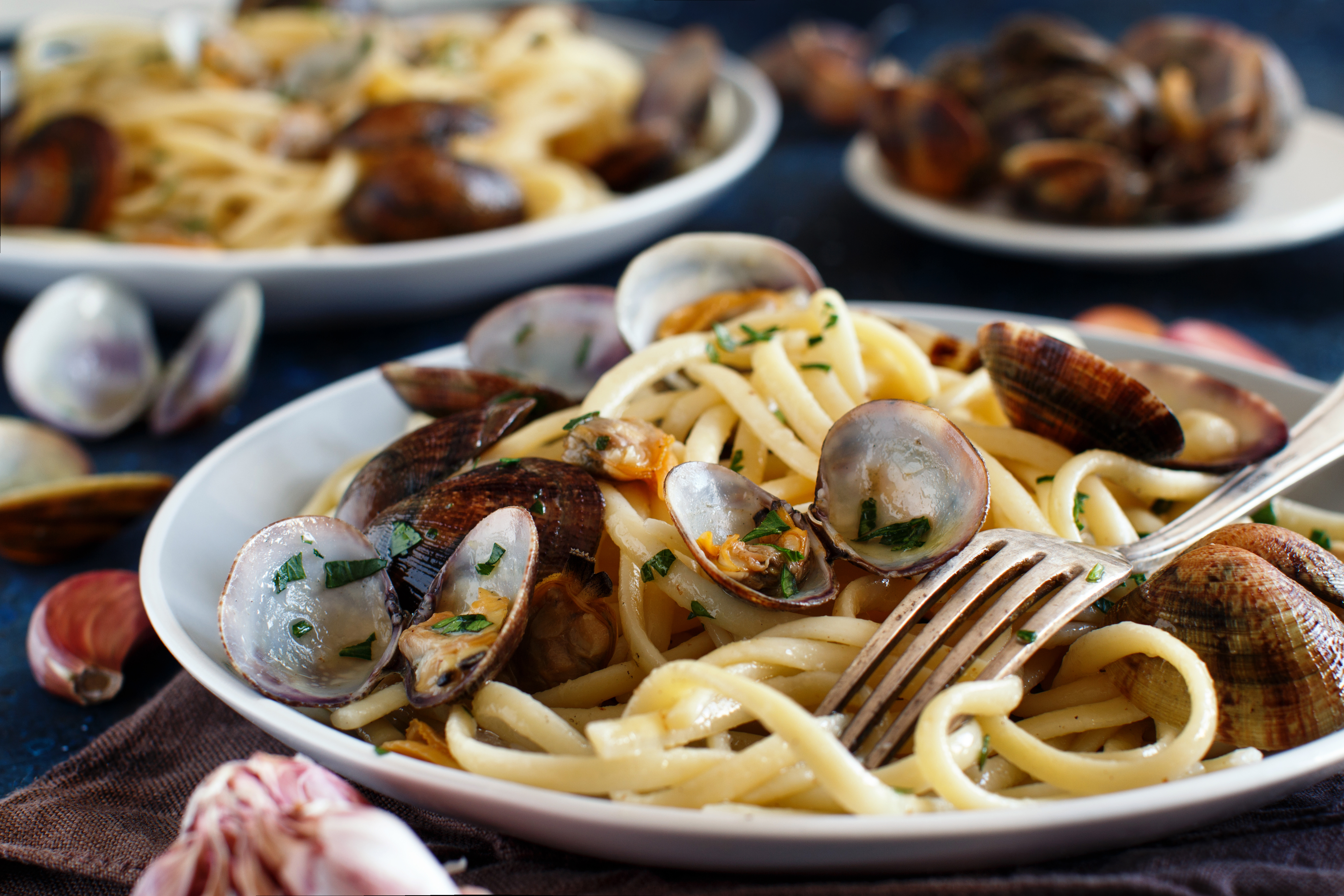 Plate of linguine pasta with clams and herbs.