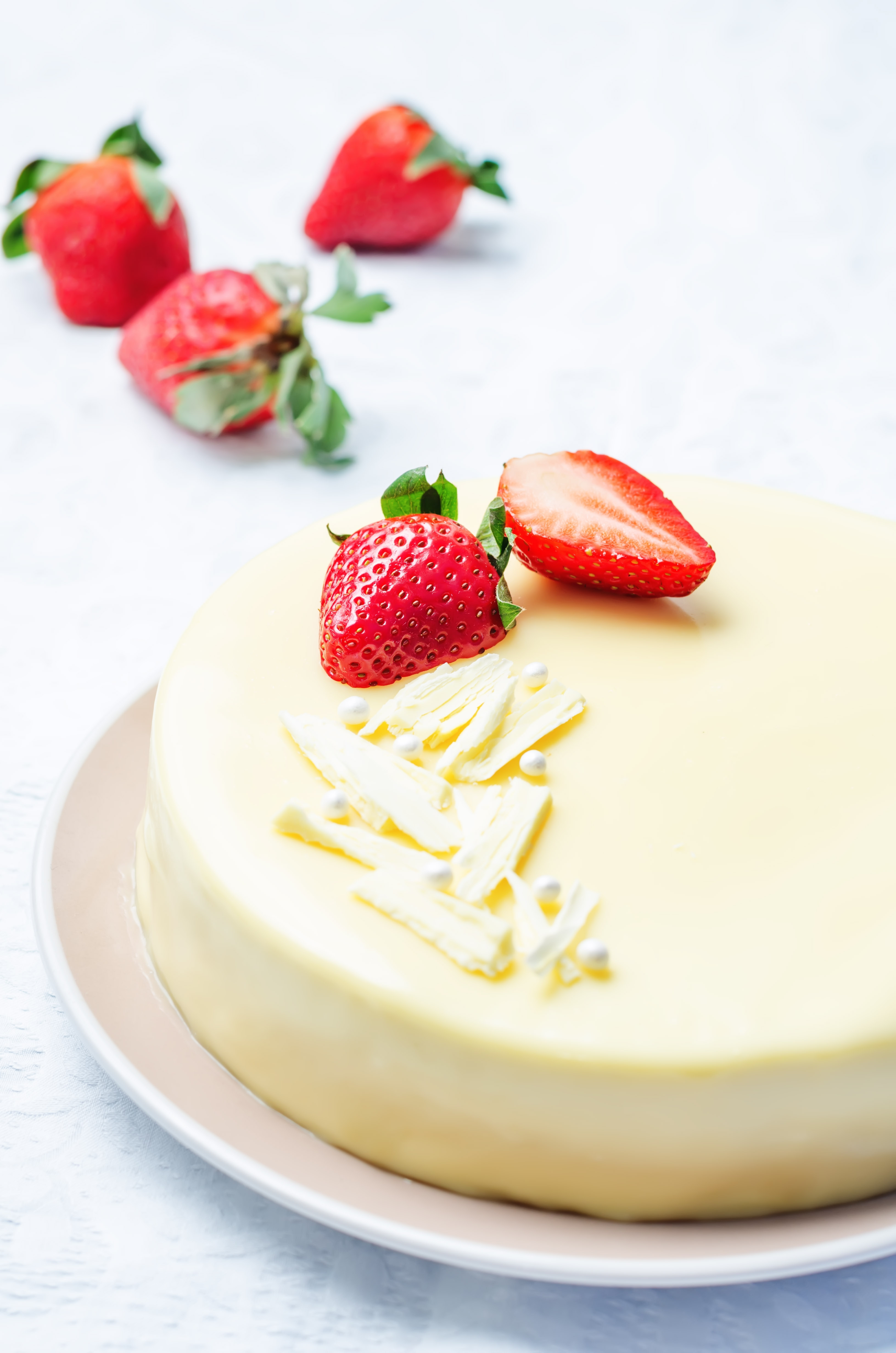 White chocolate cake topped with fresh strawberries.
