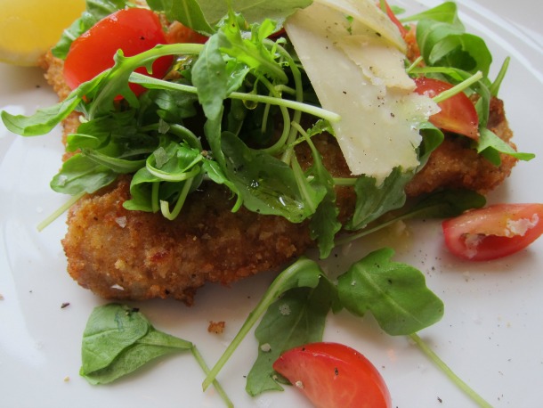 Crispy breaded chicken topped with fresh arugula, cherry tomatoes, and shaved parmesan.