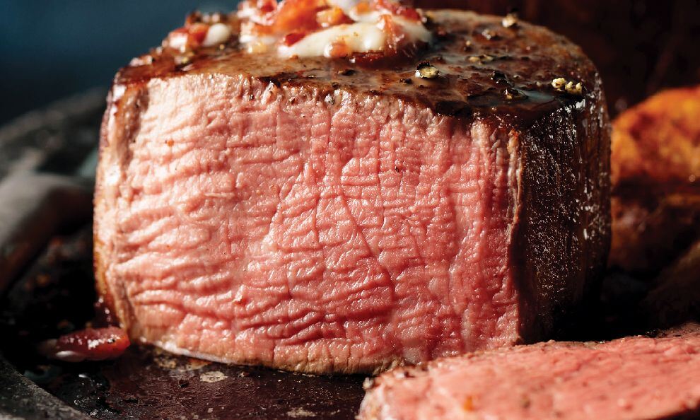 Close-up of a juicy medium-rare steak with a browned crust.